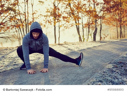 Male runner doing stretching exercise